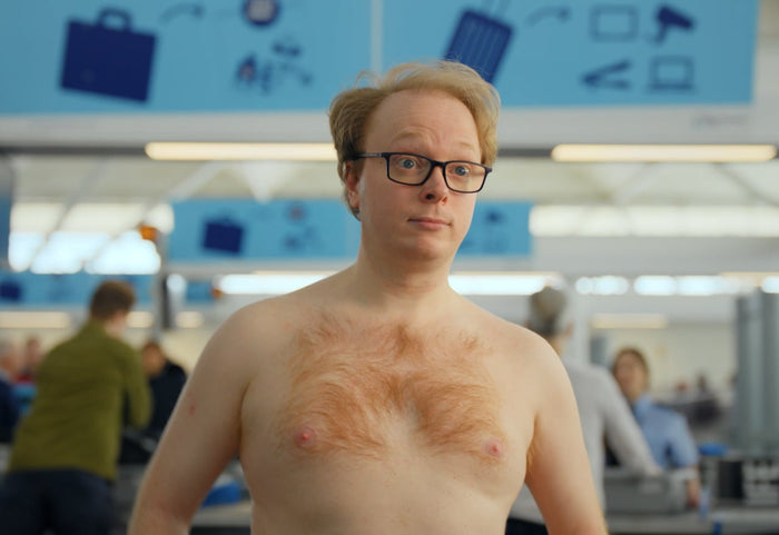 Man at airport security in the UP-UP chocolate commercial