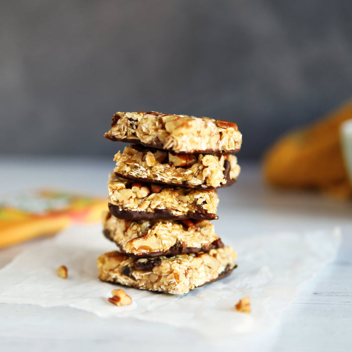 Pecan granola bars topped with dark chocolate