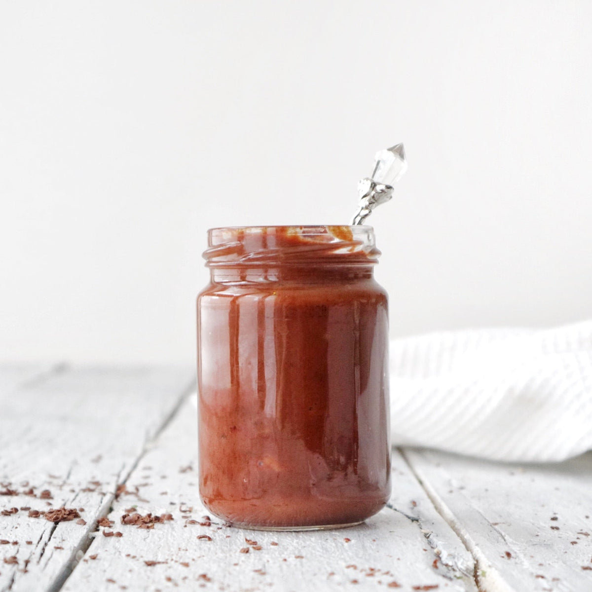 Jar of chocolate BBQ sauce beside a veggie burger
