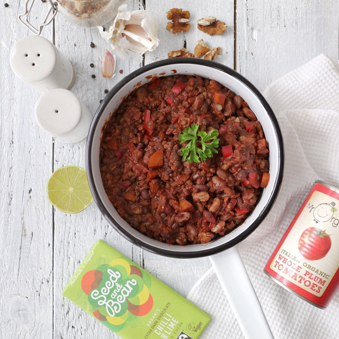 Bowl of bean chilli with walnuts and chocolate