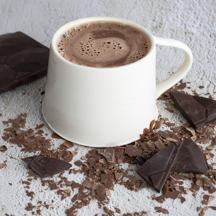 Autumn chocolate bars and hot chocolate among fallen leaves