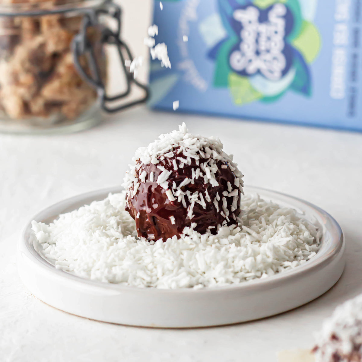 Chocolate-coated apple and hazelnut bites rolled in coconut and walnuts