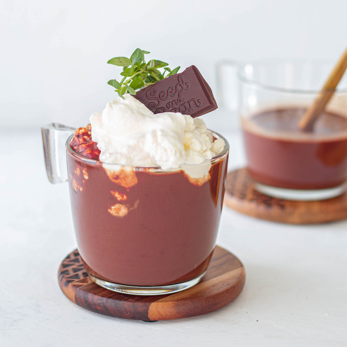 Two mugs of orange and thyme hot chocolate