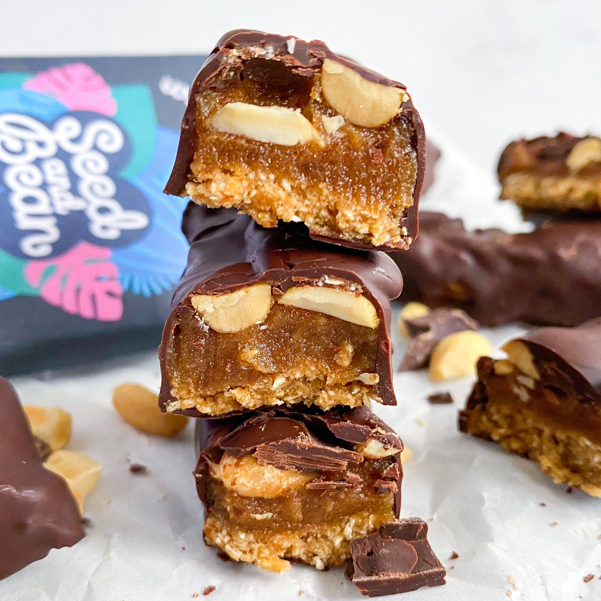 Homemade chocolate-coated caramel peanut bars cut into slices