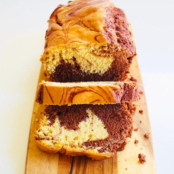 Slices of orange and thyme marble loaf cake