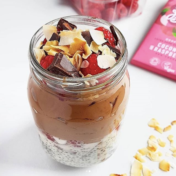 Raspberry chia pudding layered with chocolate mousse in a glass