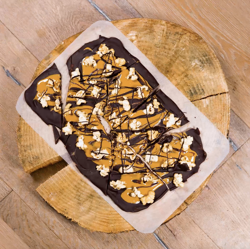 Chocolate peanut butter bark pieces with popcorn