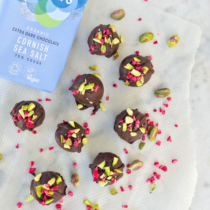 Salted peanut truffles topped with pistachios and raspberries