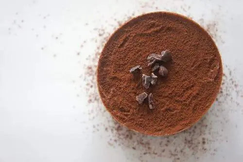 Alcohol-filled chocolates beside a glass of whisky