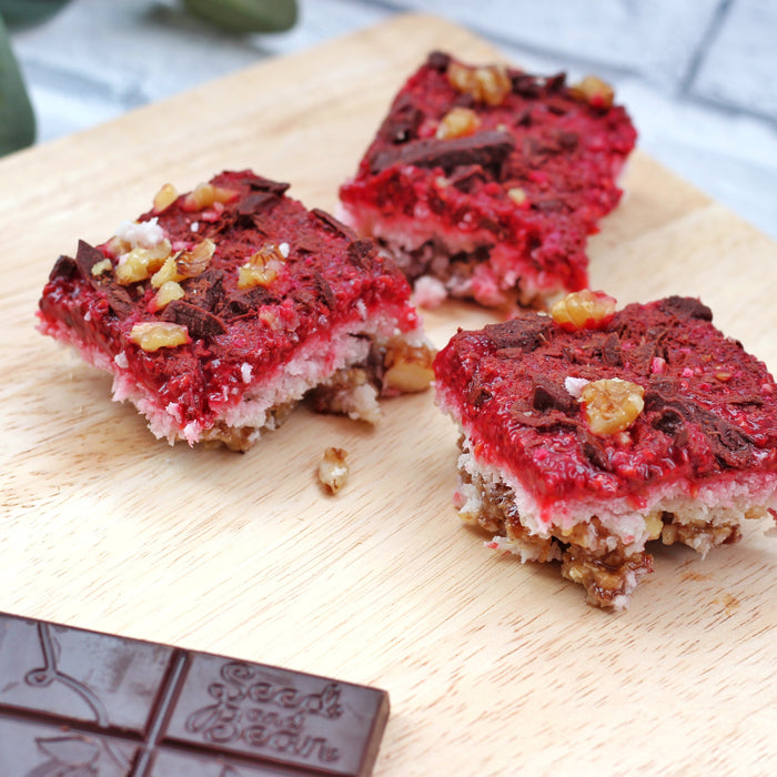 Coconut and raspberry squares topped with dark chocolate