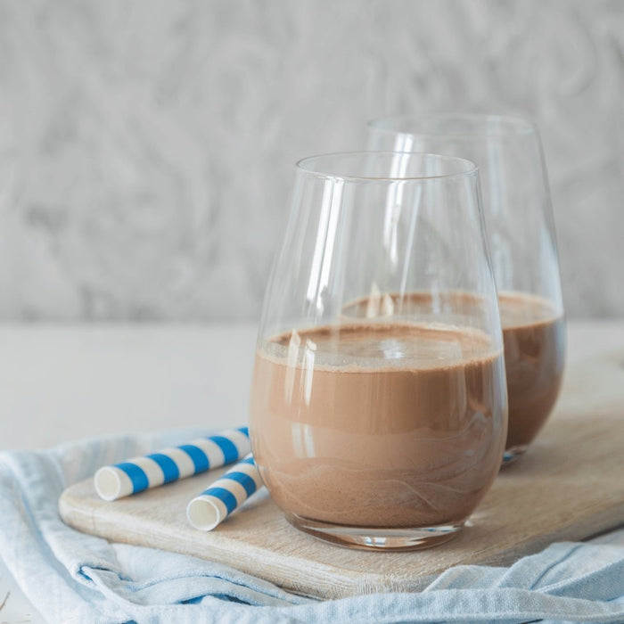 Glass of homemade vegan chocolate oat milk