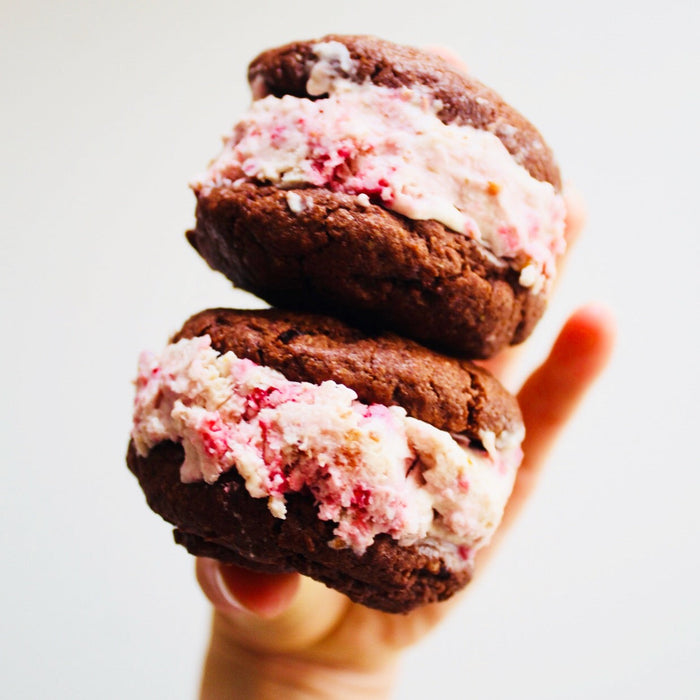 Chocolate cookie ice cream sandwiches with raspberries