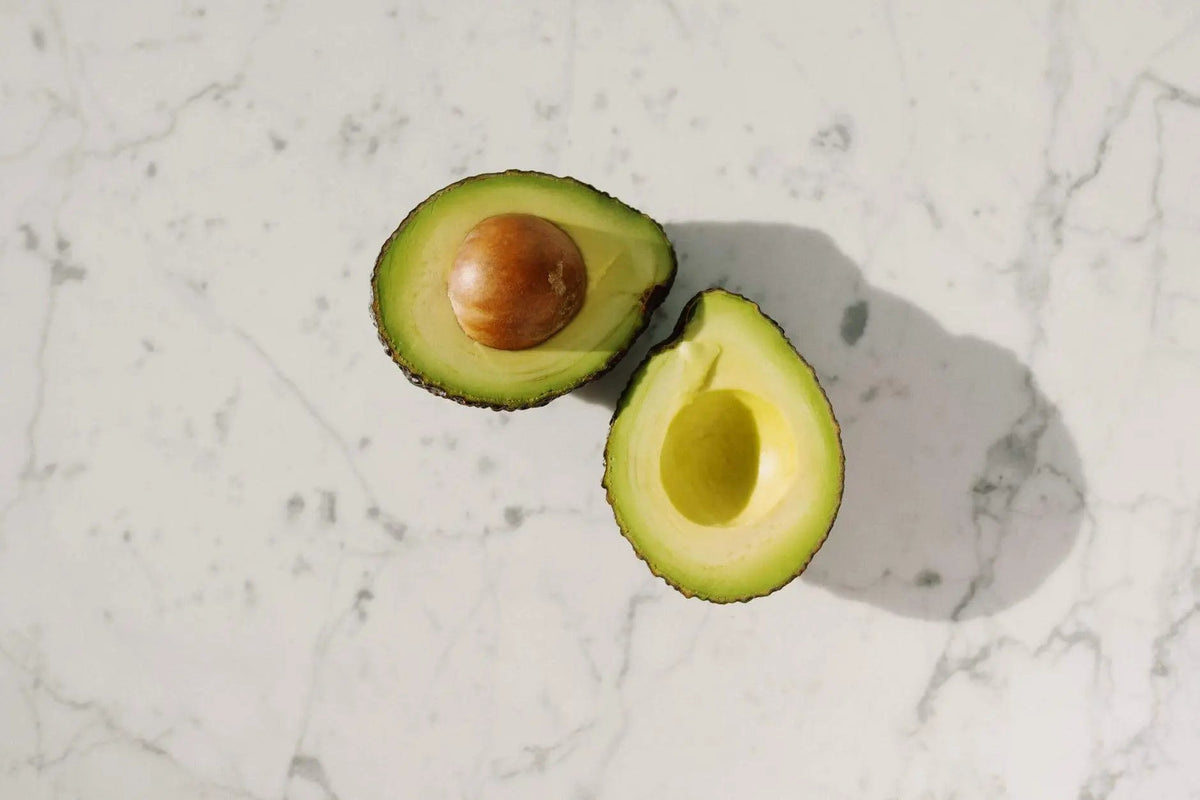 Avocado chocolate bar beside a halved avocado