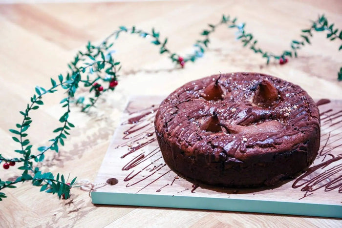 Vegan chocolate cake topped with chai-poached pears