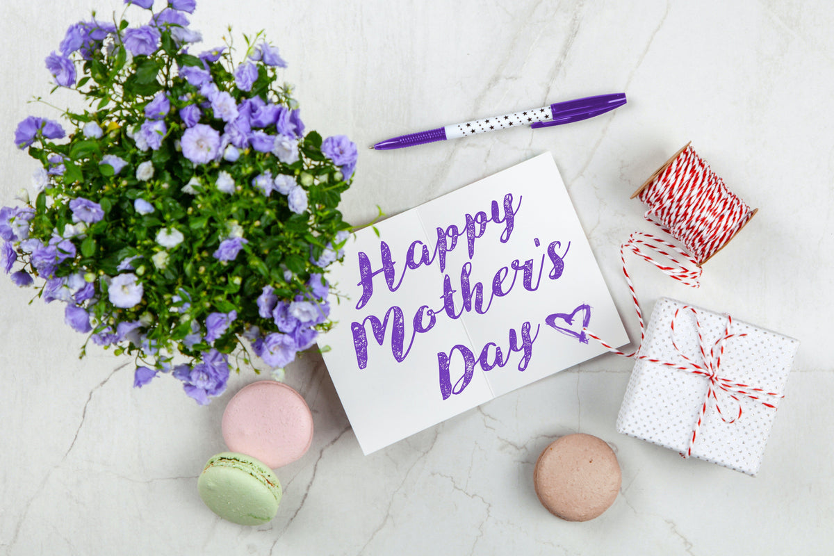 Box of Mother's Day chocolates with spring flowers