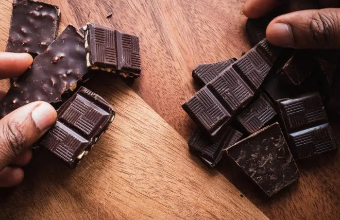 Dark, milk and white chocolate squares on a board