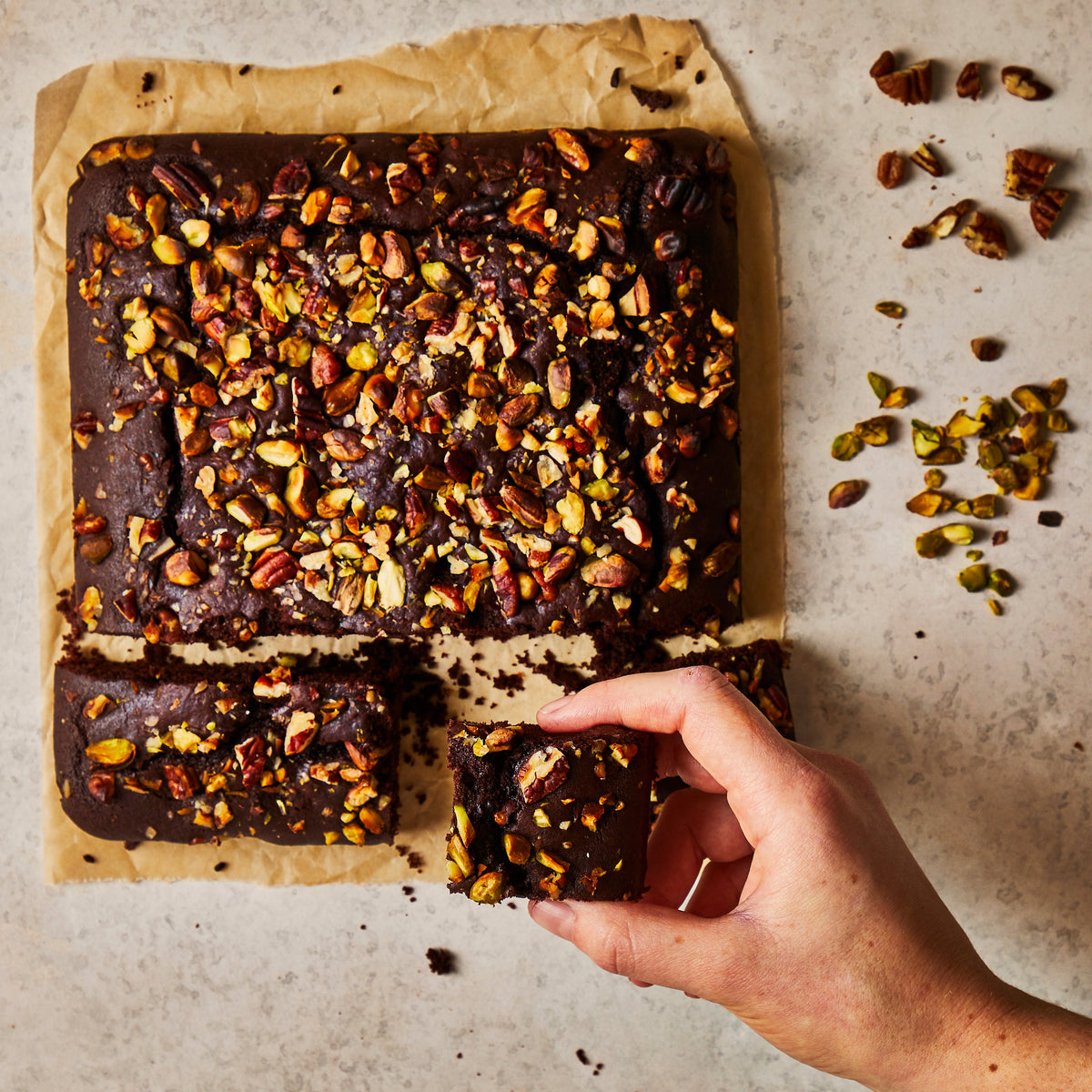 Vegan chocolate brownies stacked on a board