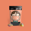 COCO Sour Apple Sweets 100g, pouch with sweets on a coral background
