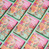 OTHERLY Orange Oat M!lk Chocolate 120g, rows of packs laid out diagonally