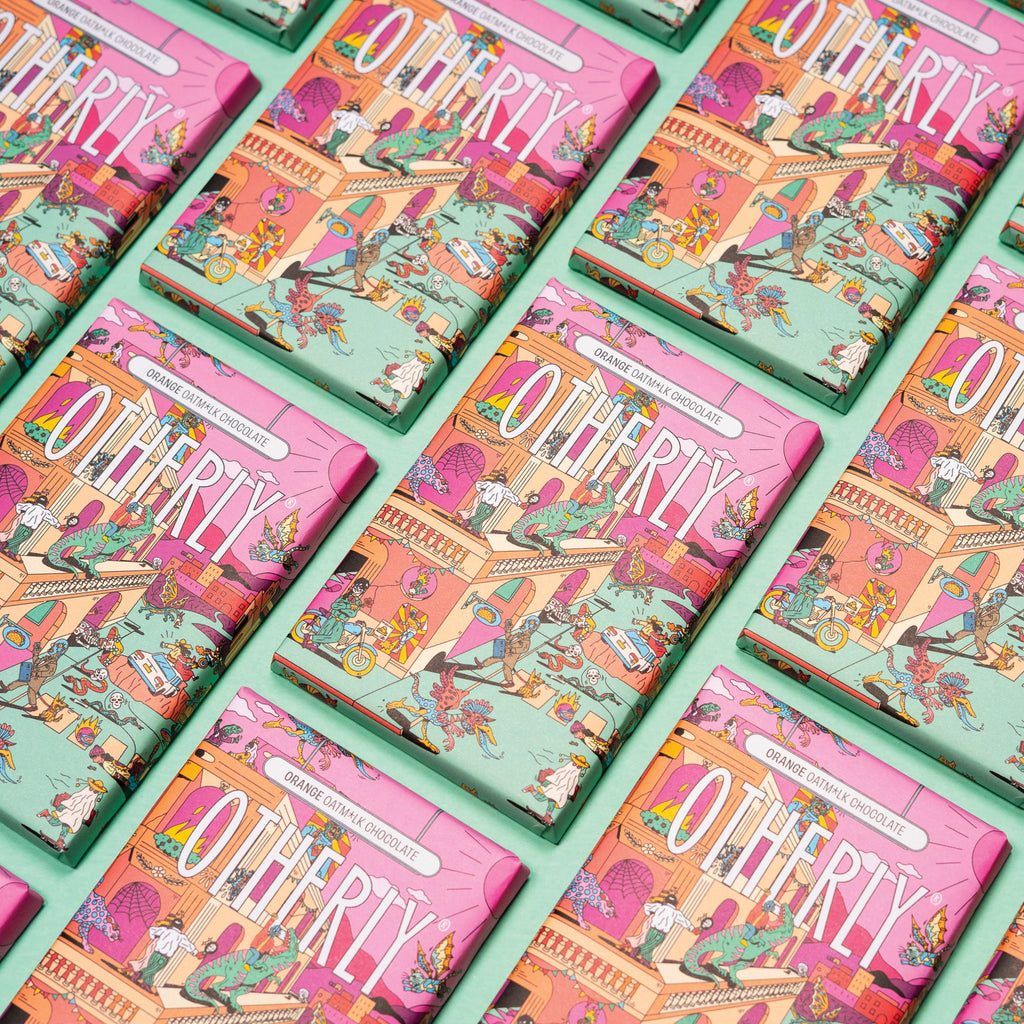 OTHERLY Orange Oat M!lk Chocolate 120g, rows of packs laid out diagonally