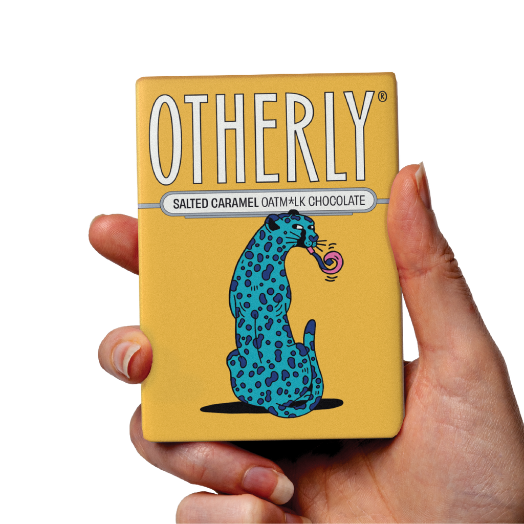 OTHERLY Salted Caramel Oat M!lk Chocolate 60g, bar held in hand