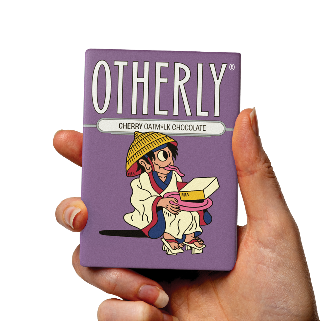 OTHERLY Cherry Oat M!lk Chocolate 60g, bar held in hand
