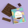 Love Cocoa Colombian Single Origin 41% Milk Chocolate Bar, pack with milk chocolate pieces on a lilac background
