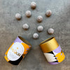 Love Cocoa Milk Chocolate Marc de Champagne Truffles, open truffle tube with truffles scattered