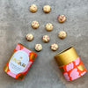 Love Cocoa Raspberry Marc de Champagne White Chocolate Truffles, open truffle tube with truffles scattered