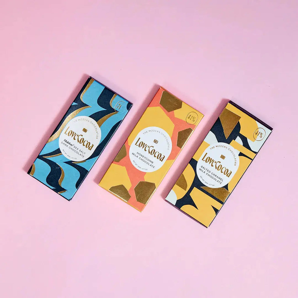 Love Cocoa Mini Salted Caramel 41% Milk Chocolate Bar, three mini bars on a pink background
