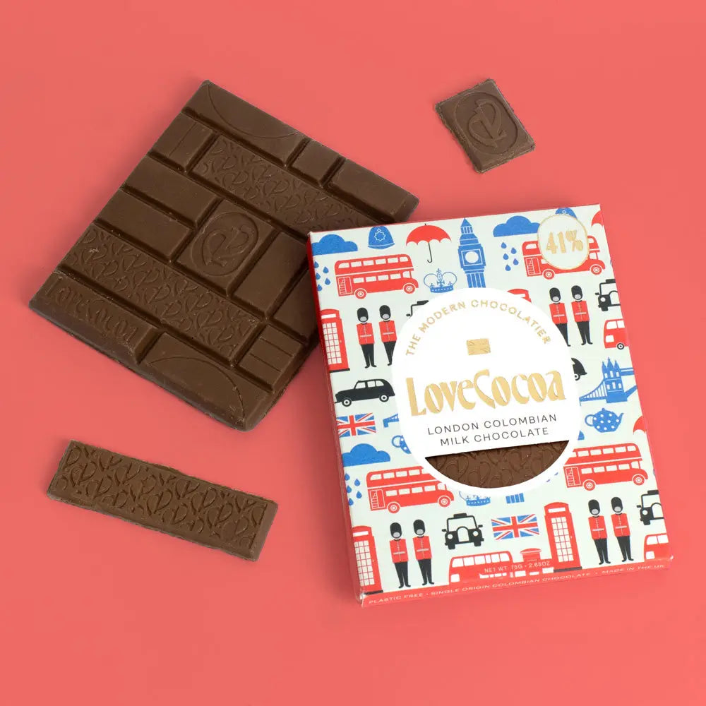 Love Cocoa London Edition Colombian Milk Chocolate Bar, pack with milk chocolate pieces on a coral background