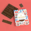 Love Cocoa London Edition Colombian Milk Chocolate Bar, pack with milk chocolate pieces on a coral background