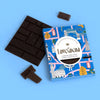 Love Cocoa London Edition British Maldon Sea Salt Dark Chocolate Bar, pack with broken pieces of dark chocolate on a blue background