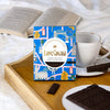 Love Cocoa London Edition British Maldon Sea Salt Dark Chocolate Bar, pack on a breakfast tray with a book and a cup