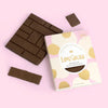 Love Cocoa Prosecco 41% Milk Chocolate Bar, pack with milk chocolate pieces on a pink background