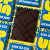 UP-UP Dark Sea Salt Dark Chocolate 120g, unwrapped dark bar on a stack of packs