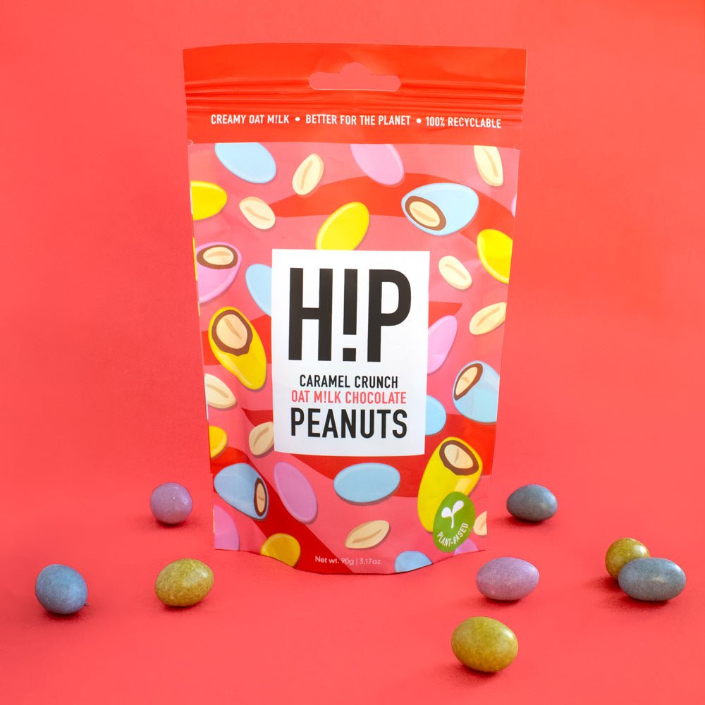 H!P Caramel Crunch Chocolate Peanuts, sharing pouch with coated peanuts on a red background