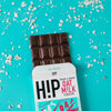 H!P Creamy Original Oat M!lk Chocolate bar, bar half out of its wrapper on a turquoise background