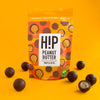 H!P Peanut Butter Chocolate Truffle Bites, sharing pouch with truffle bites on a yellow background