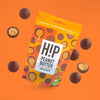 H!P Peanut Butter Chocolate Truffle Bites, sharing pouch with truffle bites on an orange background
